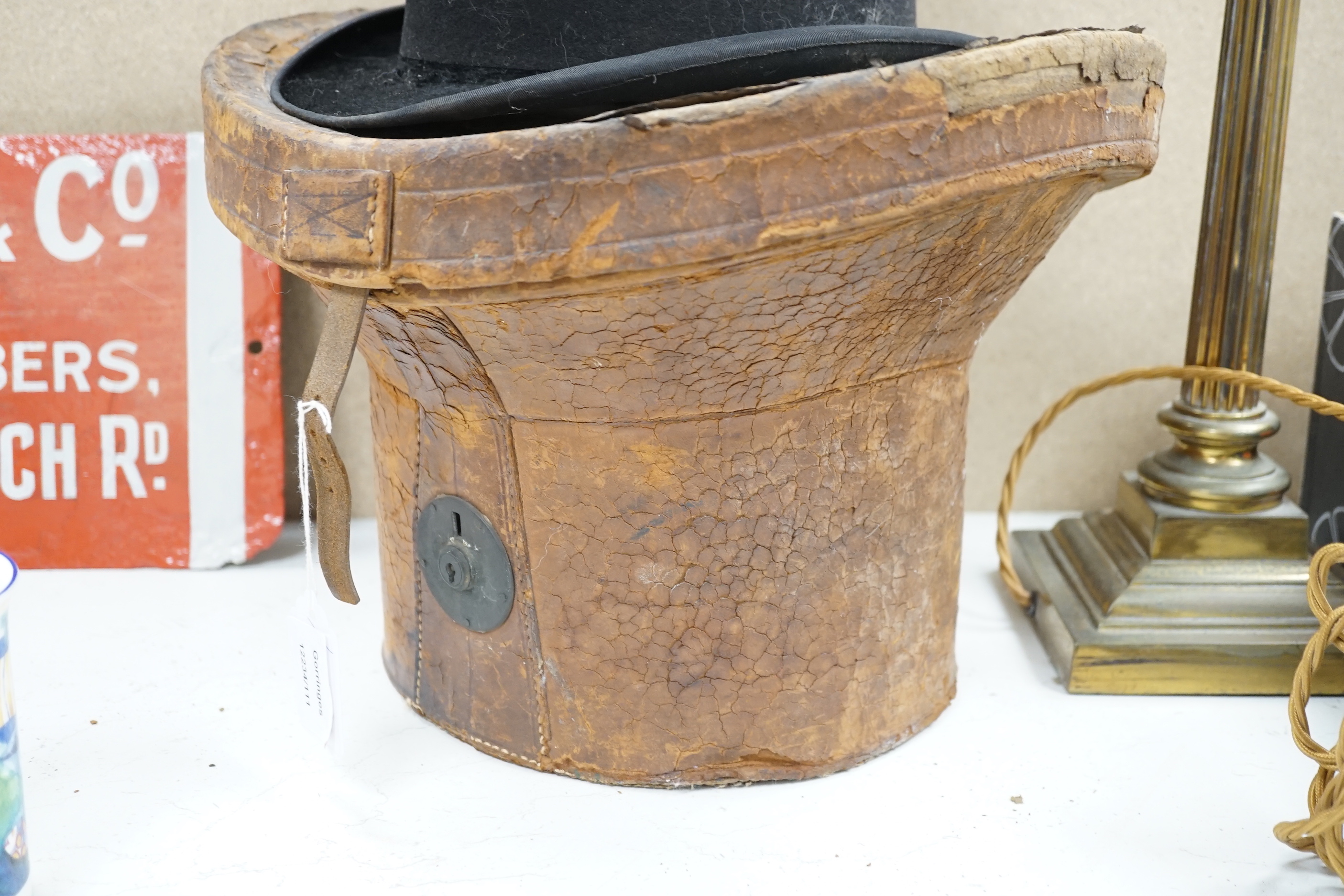 A top hat, in leather case